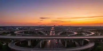 Modern highway and bridge infrastructure at sunset, illustrating the impact of federal funding on transportation networks.